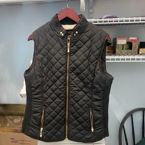 Black winter vest with white sheep like lining. Lots of use left. Size Large